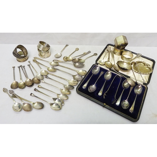 407 - Silver and silver plate: a cased set of six teaspoons, sugar tongs lacking; seven various napkin rin... 
