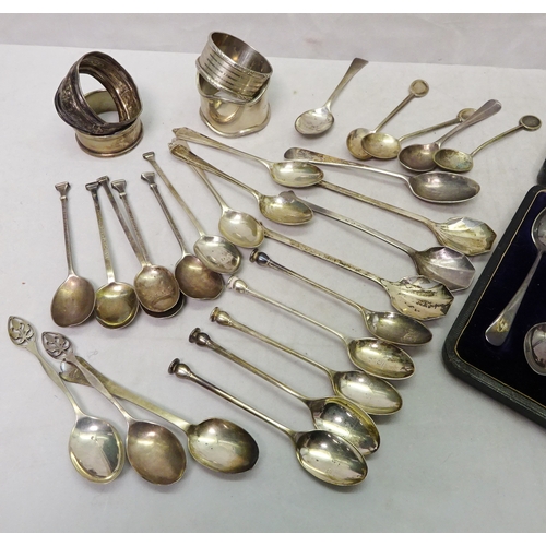 407 - Silver and silver plate: a cased set of six teaspoons, sugar tongs lacking; seven various napkin rin... 