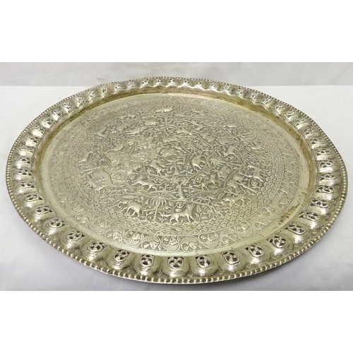 408 - An Indian repousse white metal tray having a radiating landscape design incorporating animal, tree a... 