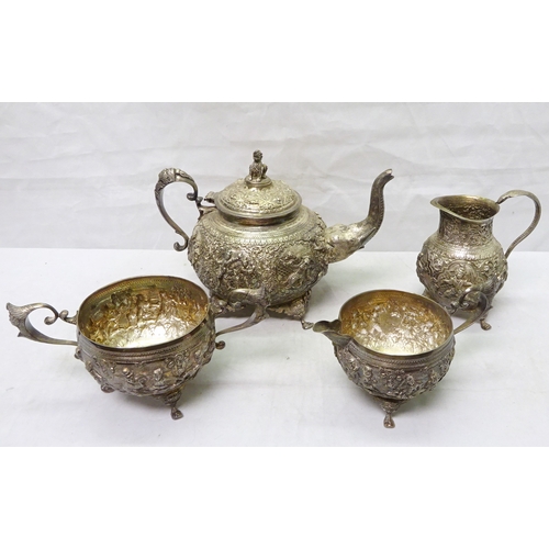 409 - An Anglo Indian four piece tea set comprising teapot, two jugs, and a sugar bowl, white metal having... 