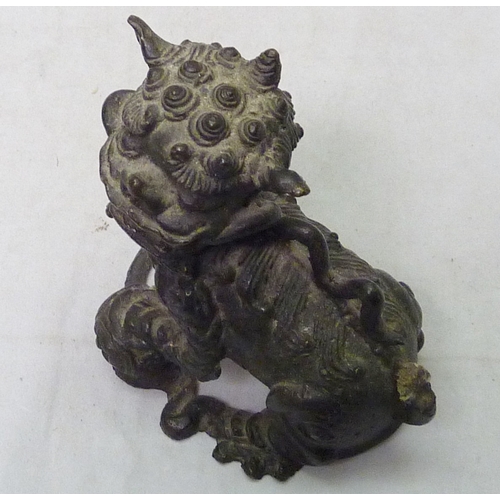 273 - A Chinese temple lion / dog of fo in cast bronze, 11cm tall, a/f; a Chinese censer / vase table lamp... 