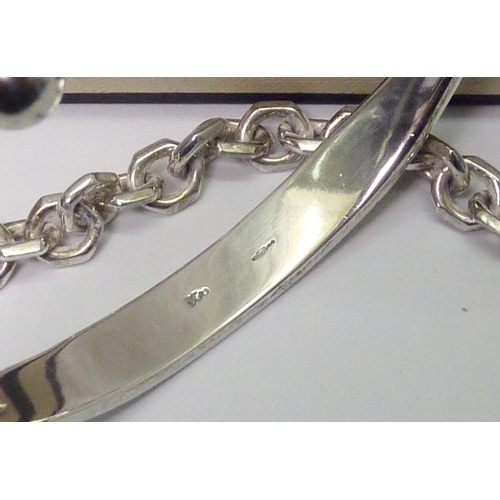 217 - A Links of London chain link bracelet, unmarked white metal; a silver torque bangle.