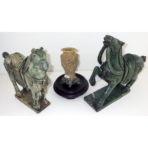 128 - Two Oriental polished stone horses together with a small carved soapstone spill vase (3)