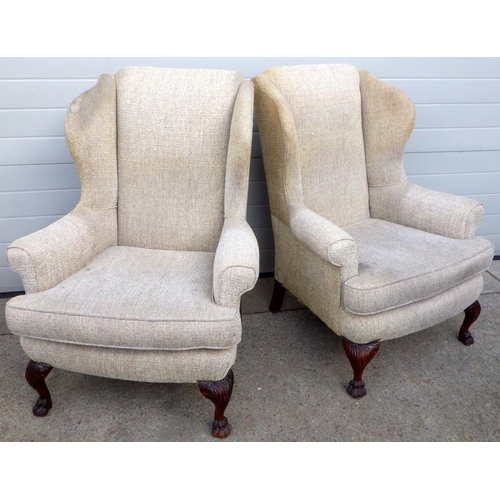 830 - A pair of wingback armchairs on carved paw feet, upholstery a/f