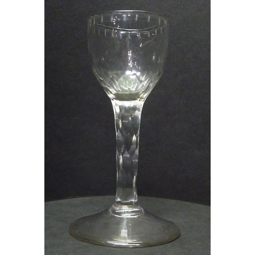 265 - A drinking glass having a facet cut stem and cut decoration to the rim.  c1800.  129mm.