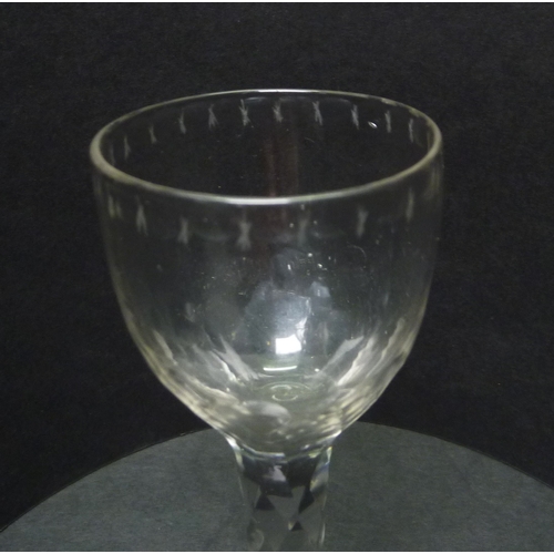 265 - A drinking glass having a facet cut stem and cut decoration to the rim.  c1800.  129mm.