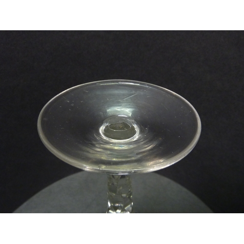 265 - A drinking glass having a facet cut stem and cut decoration to the rim.  c1800.  129mm.