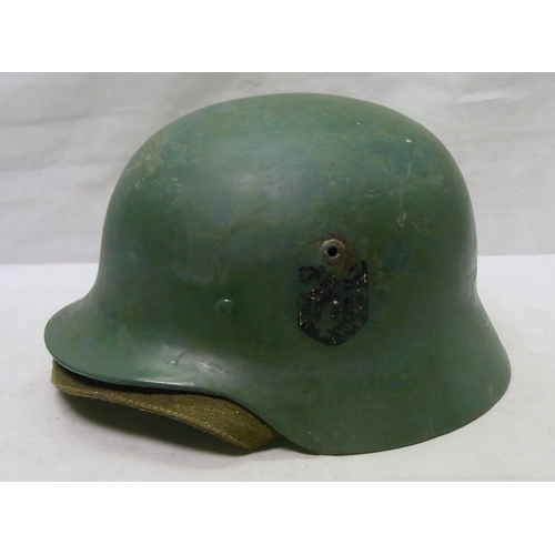 238 - Military interest: a German m40? helmet with liner, overpainted / restored.