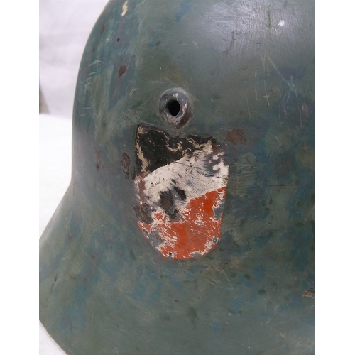 238 - Military interest: a German m40? helmet with liner, overpainted / restored.
