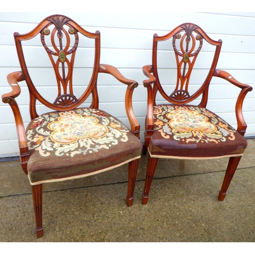 A pair of Hepplewhite style carver chairs with partial painted back and needlework seats