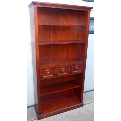 841 - A tall reproduction mahogany open bookcase with three central drawers, 94cm wide x 184cm tall
