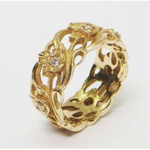 26 - A Stuart Devlin Gold & Diamond daffodil motif eternity ring, comprising seven brilliant cut white st... 