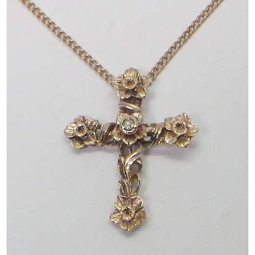 27 - A Stuart Devlin Gold & Diamond Cross pendant, comprising a single diamond in a 14ct gold setting scu... 
