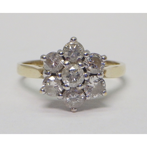 34 - A daisy cluster ring comprising six brilliant cut diamonds in an 18ct gold setting.  Diamonds each a...