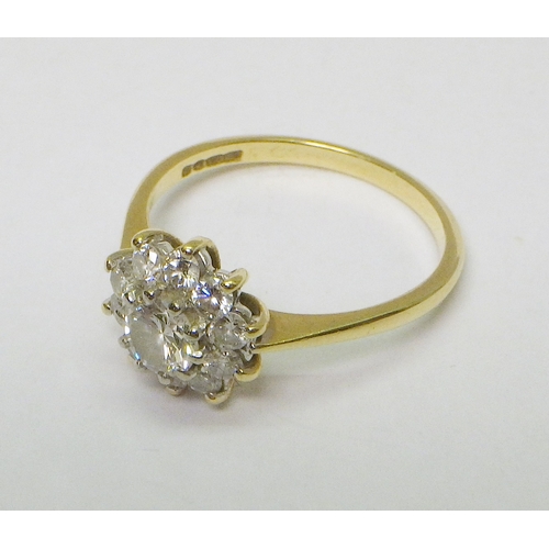 35 - A cluster ring comprising 11 brilliant cut diamonds in an 18ct gold setting.  Central diamond approx... 