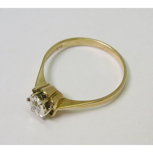 39 - A 9ct gold solitaire ring comprising a single brilliant cut diamond in a star-shaped illusion settin... 