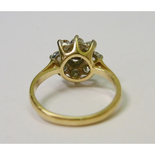 40 - A daisy cluster ring comprising eight brilliant cut diamonds surrounding a single diamond in an illu... 