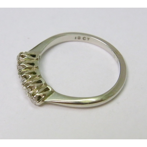 41 - An eternity ring comprising five brilliant cut diamonds in raised claw settings, white metal marked ... 