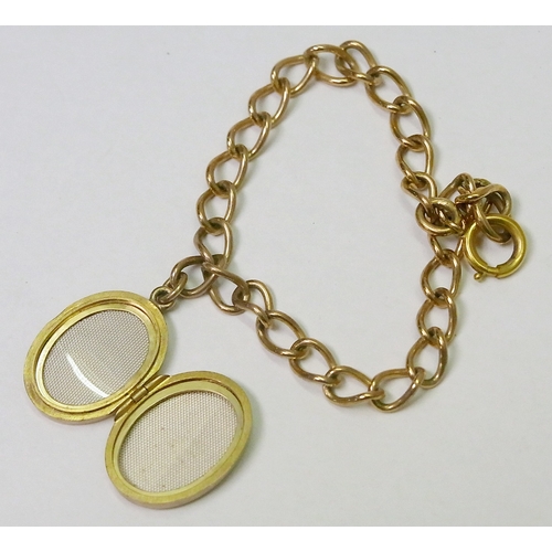 62 - A 9ct gold photograph locket on a 9ct gold chain link bracelet.  Locket 21 x 16mm oval / whole 13g g... 