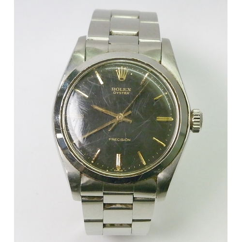 A Rolex Oyster Precision 6426 comprising a manual wind movement under a grey / black dial marked "- SWISS -" at 6 and having gilt baton indices and hands in a steel case.  The whole on a Rolex Oyster steel bracelet, this possibly a later replacement.  Some debris under crystal - possibly lume dot flake.  No box or papers.  Watch head 34mm across / 42mm lug to lug.