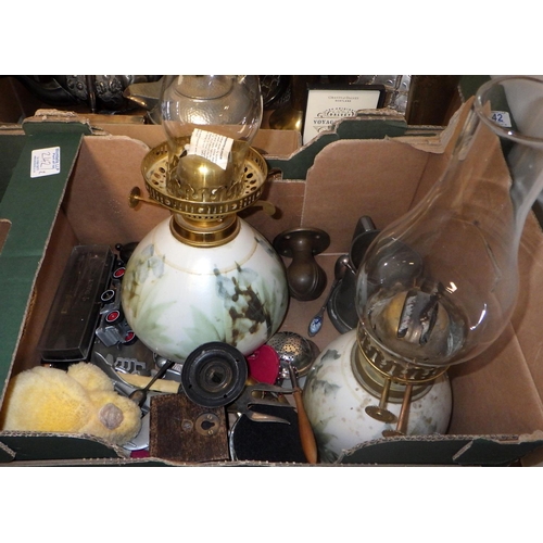 242 - A box of misc metal wares, cutlery, oil lamps etc (2)