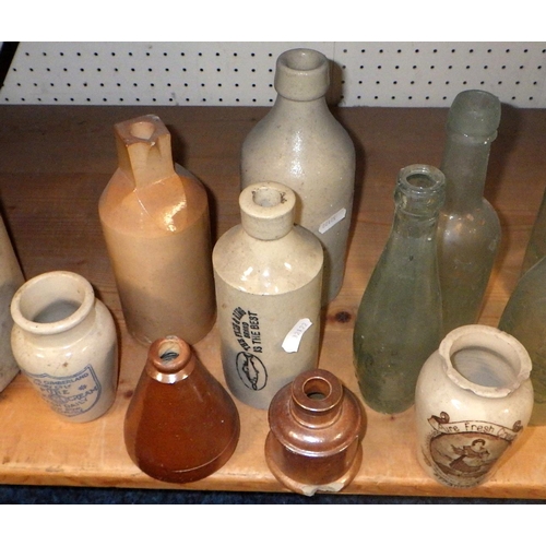 266 - A large qty of advertising glass bottles and stoneware etc