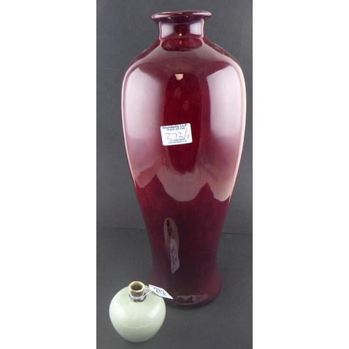 272 - A large Oriental style high fired deep red vase 46cm tall together with a small celadon vase8cm tall... 