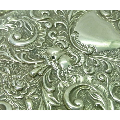 4 - A late Victorian silver dressing set tray having repousse decoration incorporating a green man motif... 