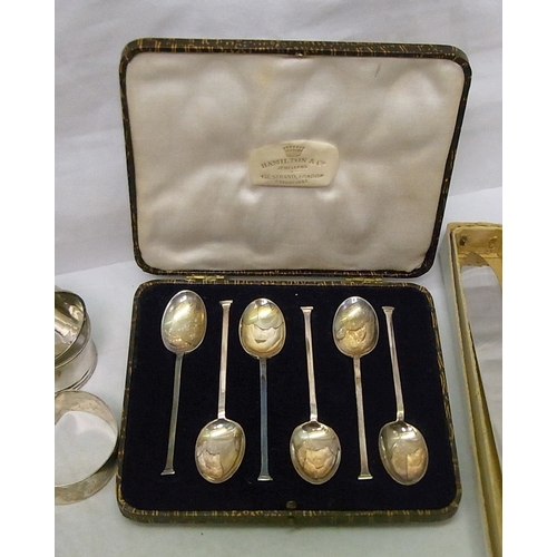 9 - A cased set of six silver coffee spoons; another similar set; four single silver napkin rings; two s... 