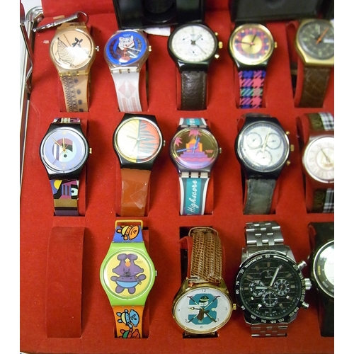 86 - A collection of seventeen Swatch watches, all used, some straps a/f, many with boxes; other watches ... 