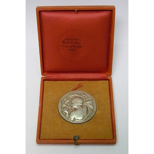 101 - An Art Deco prize medal by R Cochet / J. D'Estray, silvered bronze, 50mm diameter. Cased.