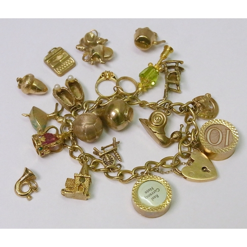 112 - A 9ct gold bracelet set with 14 9ct gold and yellow metal charms; 5 loose 9ct gold bracelet charms.