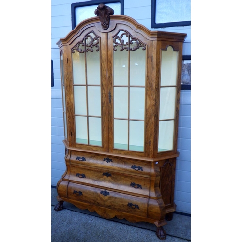 704 - A reproduction Dutch style two section cabinet with arched top and bombe base, approx 145cm wide