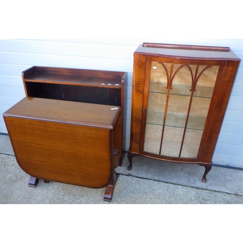 718 - A walnut China cabinet, oak sliding door bookcase and a drop leaf table (3)