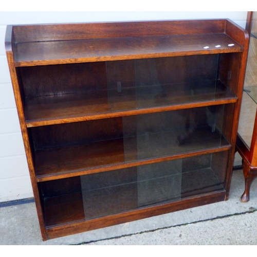 718 - A walnut China cabinet, oak sliding door bookcase and a drop leaf table (3)