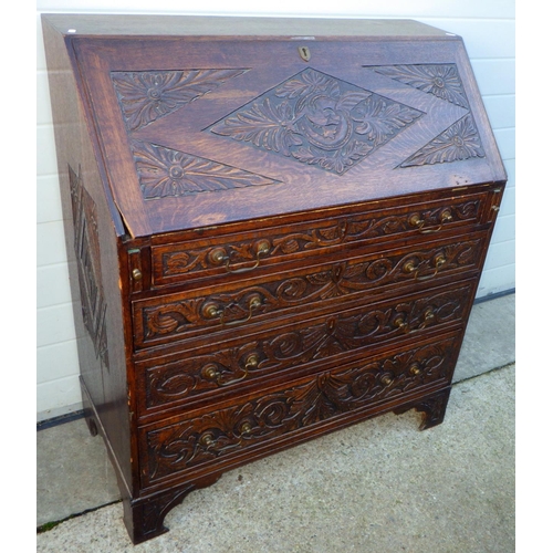 733 - A carved oak bureau (a/f), 99cm wide