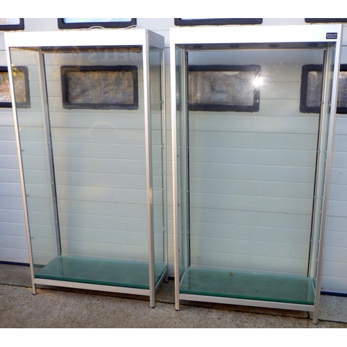 739 - Two tall modern display cabinets, 100cm wide, 192cm tall with doors and shelves, in need of re-wire