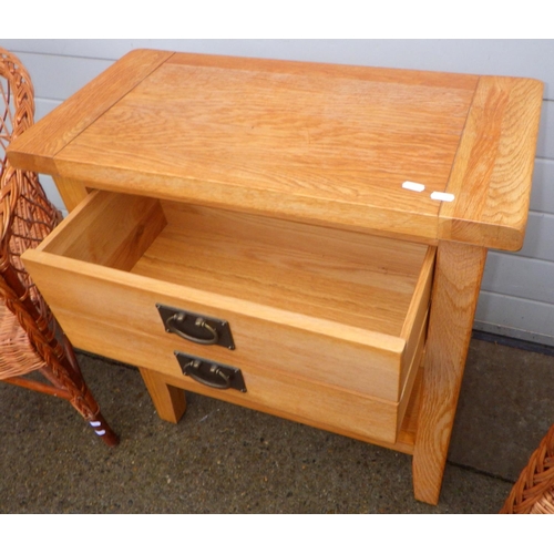 750 - A modern oak side table with single drawer together with two wicker chairs (3)