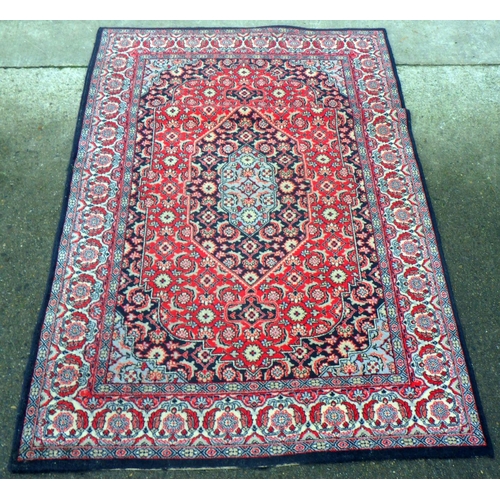 771 - A red ground rug, 176cm x 122cm