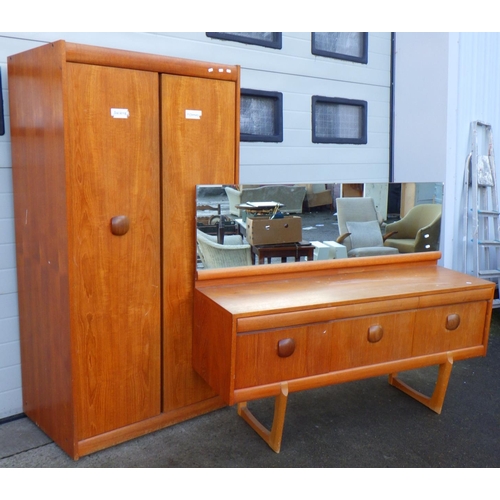 774 - An Elliot of Newbury  teak wardrobe, 90cm wide together with a matching dressing table, chip to mirr... 