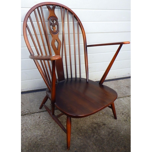 783 - A dark Ercol armchair with fleur du leys back