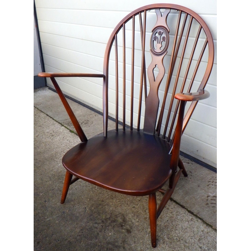 783 - A dark Ercol armchair with fleur du leys back