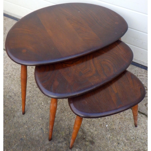 784 - A pebble nest of three dark Ercol occasional tables