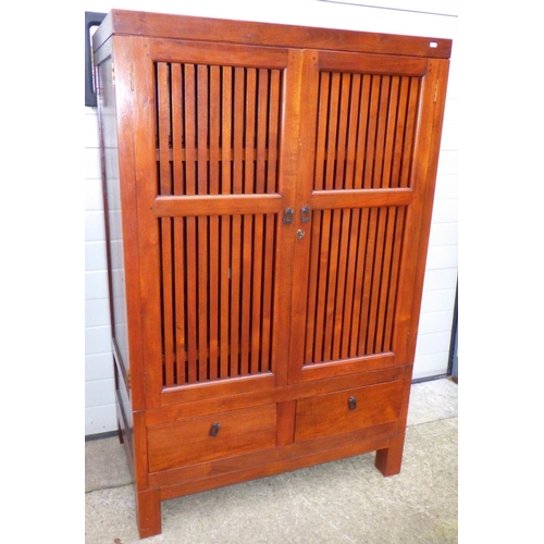 795 - An Oriental hardwood television cabinet, 106cm wide, 164cm tall