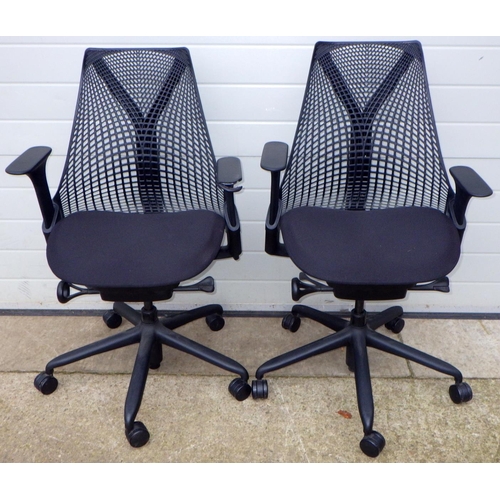 803 - Two Herman Miller office swivel chairs, one arm damaged