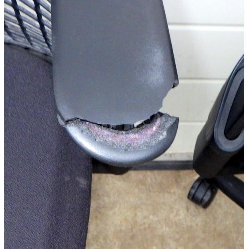 803 - Two Herman Miller office swivel chairs, one arm damaged