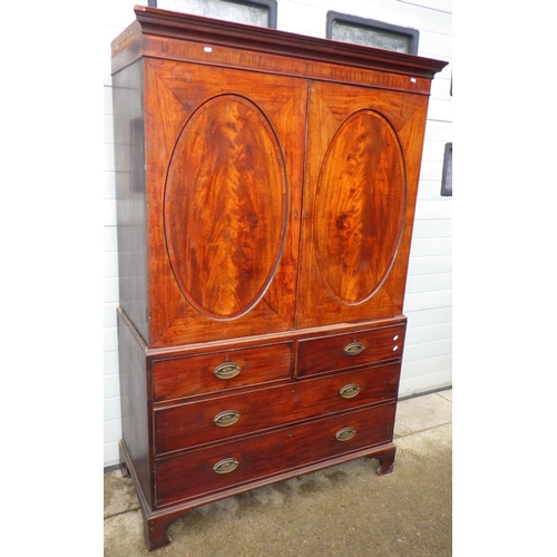 806 - A 19th cen mahogany linen press with oval panelled doors, 132cm wide, missing cornice side