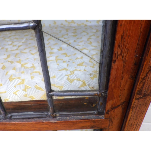 819 - A 1930's oak/ply cabinet with leaded glass doors, a/f, 65cm wide and another low cupboard (2)