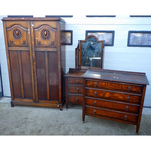 823 - A 1930's oak three piece bedroom suite, incl wardrobe, marked 122cm wide, chest and dressing chest