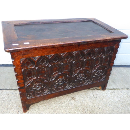 827 - An oak/ply blanket box with carved front, 72cm wide